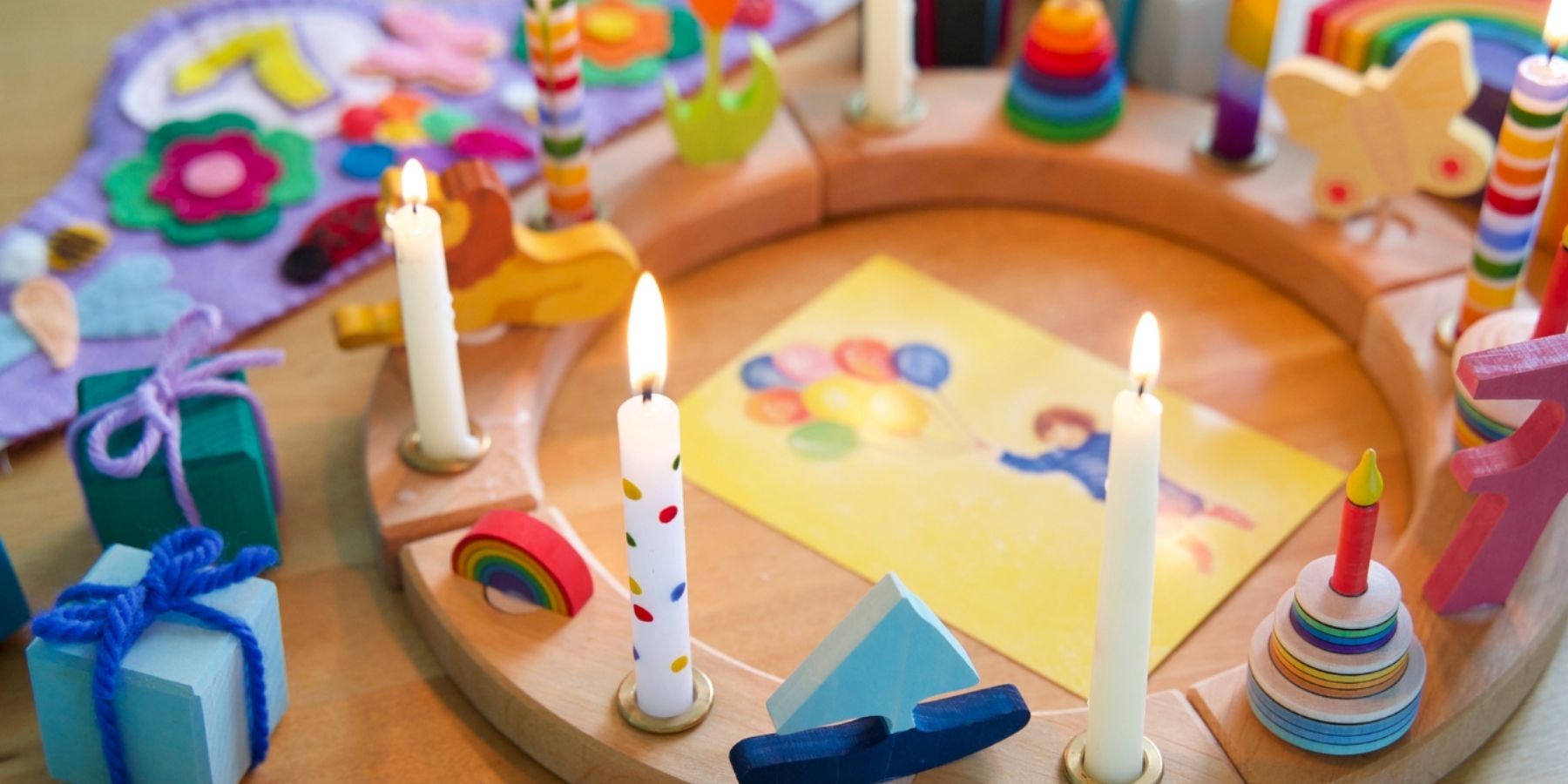 Grimm's Celebration Ring styled for a Birthday celebration with decorations, candles, toys and artwork
