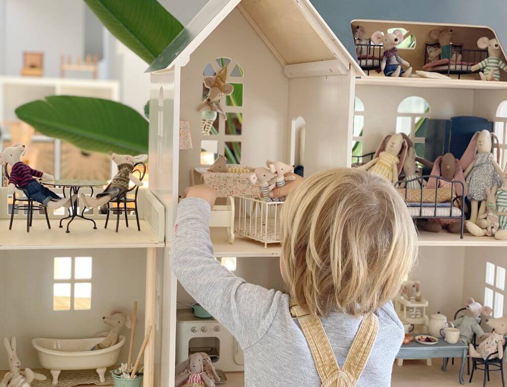 Child playing with Maileg mice in large doll's house available from Oskar's Wooden Ark in Australia