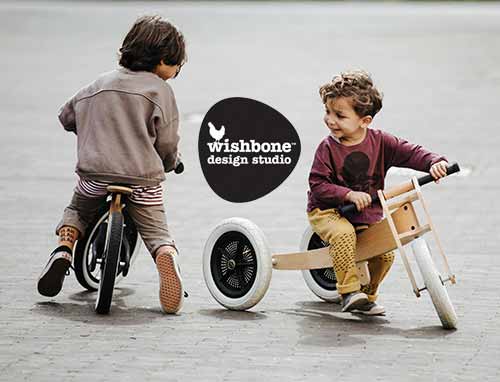 Two boys riding a Wishbone Eco-recycled plastic Balance Bike and Wooden 3-in-1 Trike from Oskar's Wooden Ark in Australia