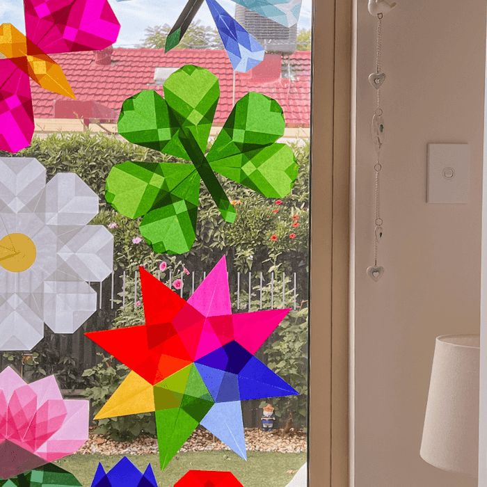 Simple kite paper window art display on the window, beautifully catching the light.
