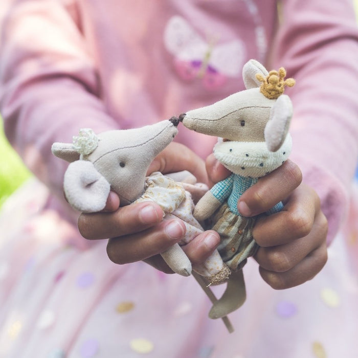 Maileg Princess and Prince mouse in the hands of a you girl, playing out a fairytale story in an outdoor setting
