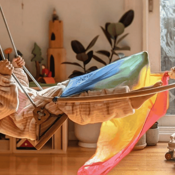 A girl playing on a Solvej Swing.