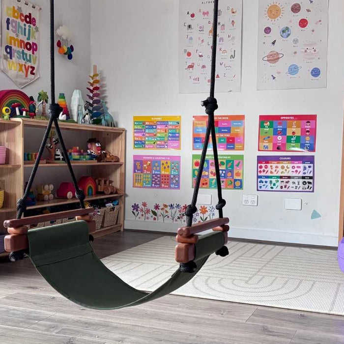 A Solvej Swing hanging in a playroom surrounded by familiar OWA toys.