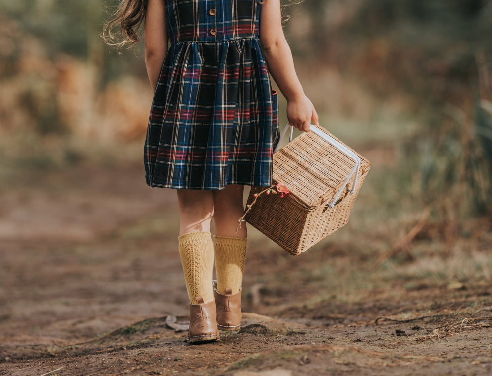 Child carrying Olli Ella Basket on an outdoor nature trail adventure at Oskar's Wooden Ark in Australia