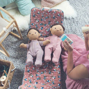 Girl absorbed in imaginative open ended role play with Olli Ella Dinkum Dolls and accessories