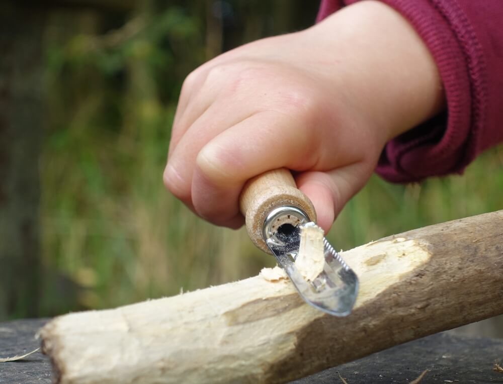 Outdoor Classroom whittling activity using Kids at Work whittling peeler at Oskar's Wooden Ark in Australia