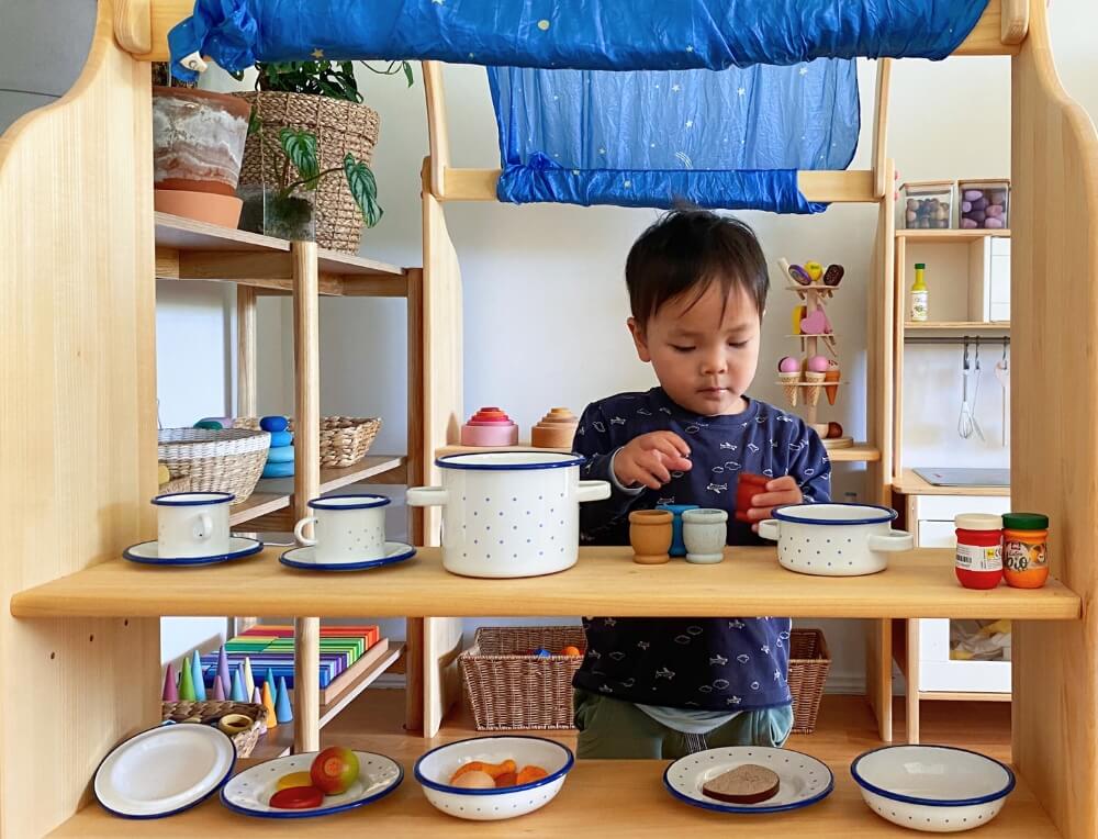 Boy playing at Schollner Wooden Playstand from Oskar's Wooden Ark in Australia