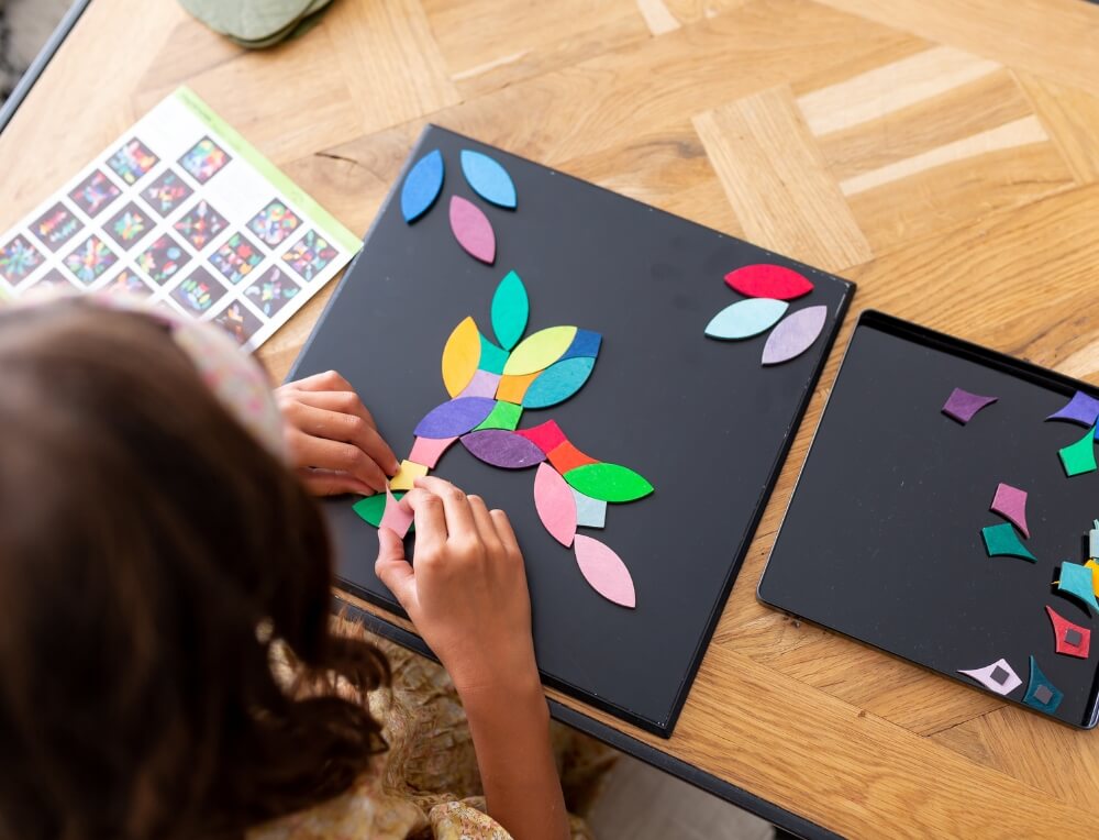 Child creating open-ended artworks with Grimm's Magnetic Puzzle