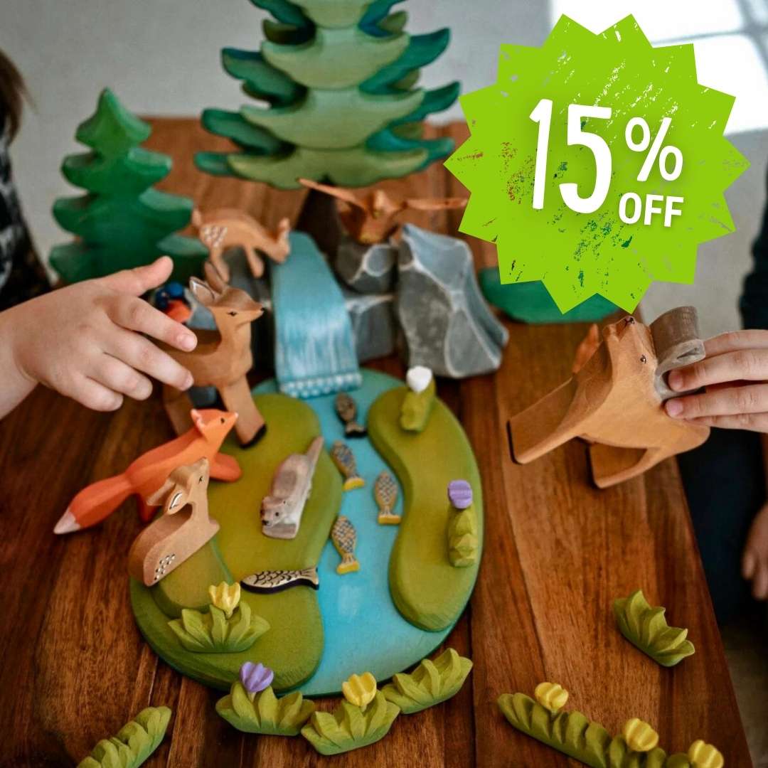 Children playing with a forest scene Bumbu toy set on a wooden table, with a 15% off discount label.