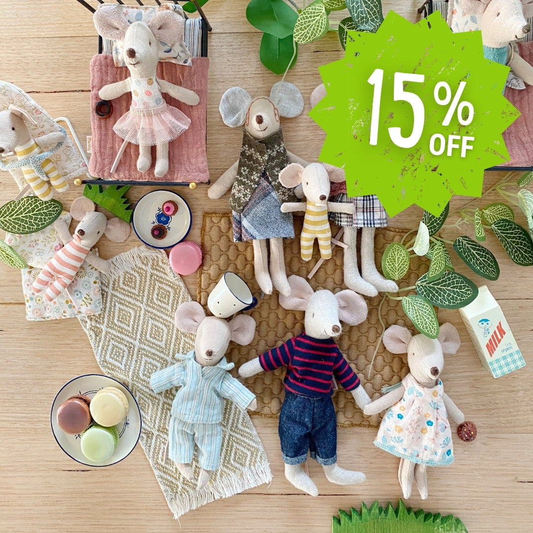 Collection of Maileg mouse dolls with clothing and accessories on a wooden surface, with a 15% off label.