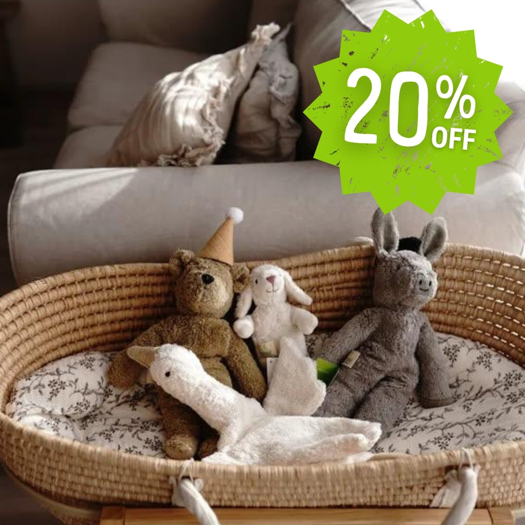 Wicker crib with SENGER stuffed animals and a 20% off discount label on a blurred background