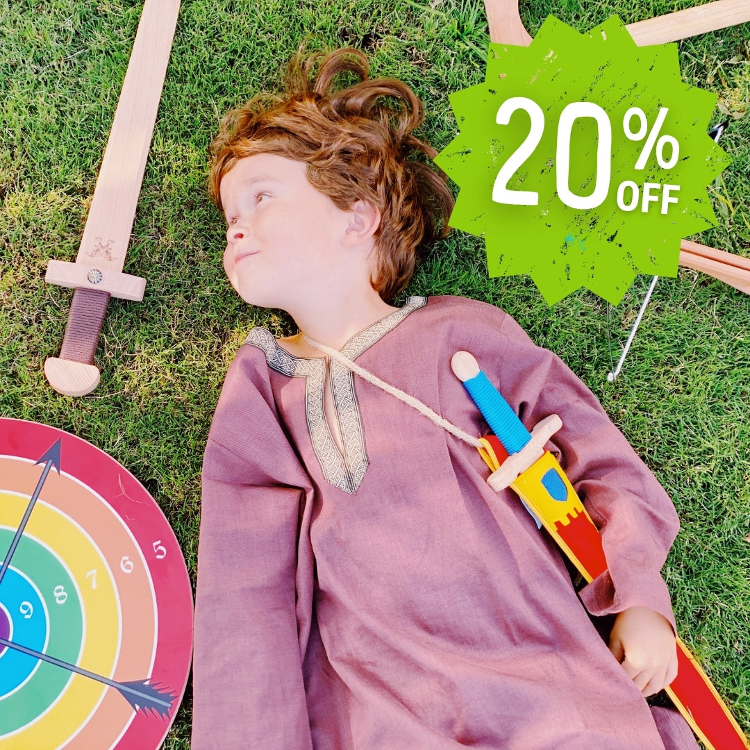 Child in VAH costume lying on grass with toys and a '20% OFF' sign.