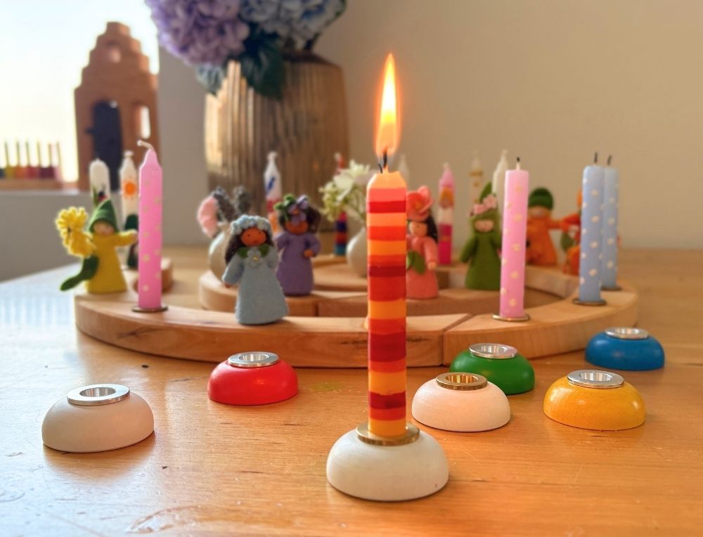 A selection of Ahrens Candle Holders & Accessories on a wooden table