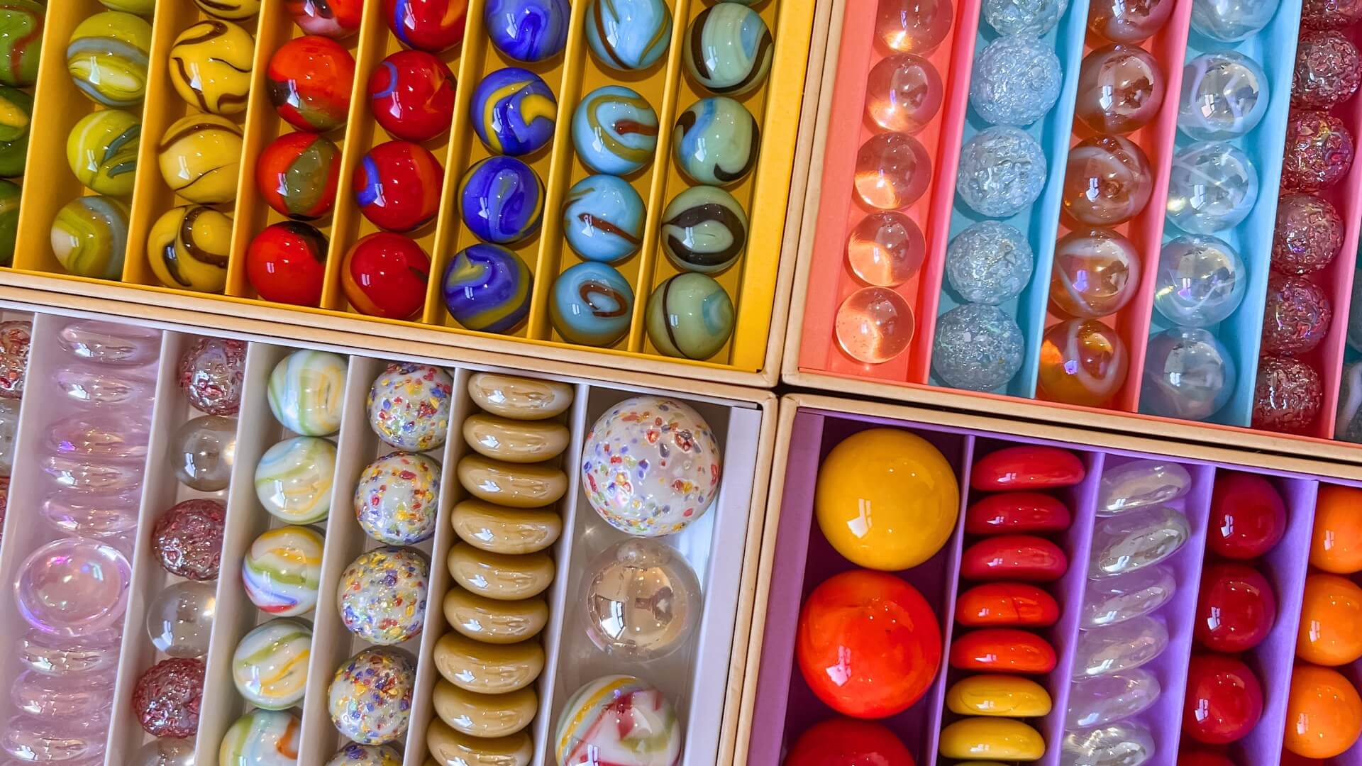 Assorted colourful Billes & Co marbles in boxes
