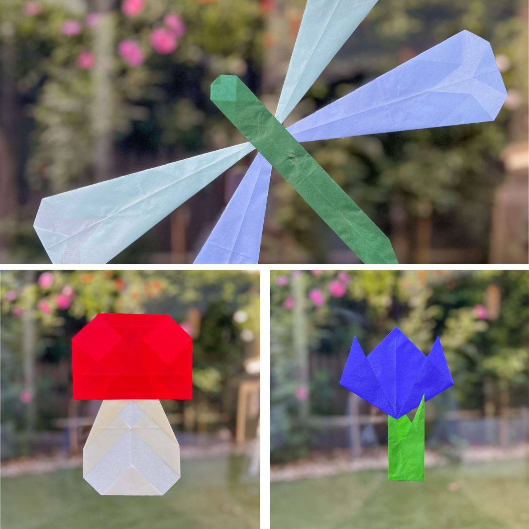 Three simple paper window designs displayed on a window.