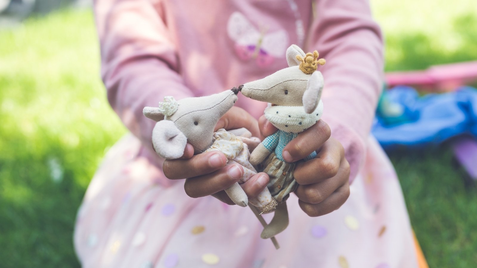 Maileg Princess and Prince mouse in the hands of a you girl, playing out a fairytale story in an outdoor setting