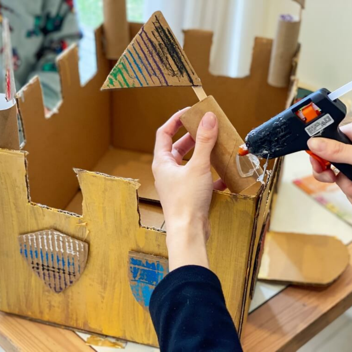 Decorated cardboard castle with paddle pop stick flags for small world play