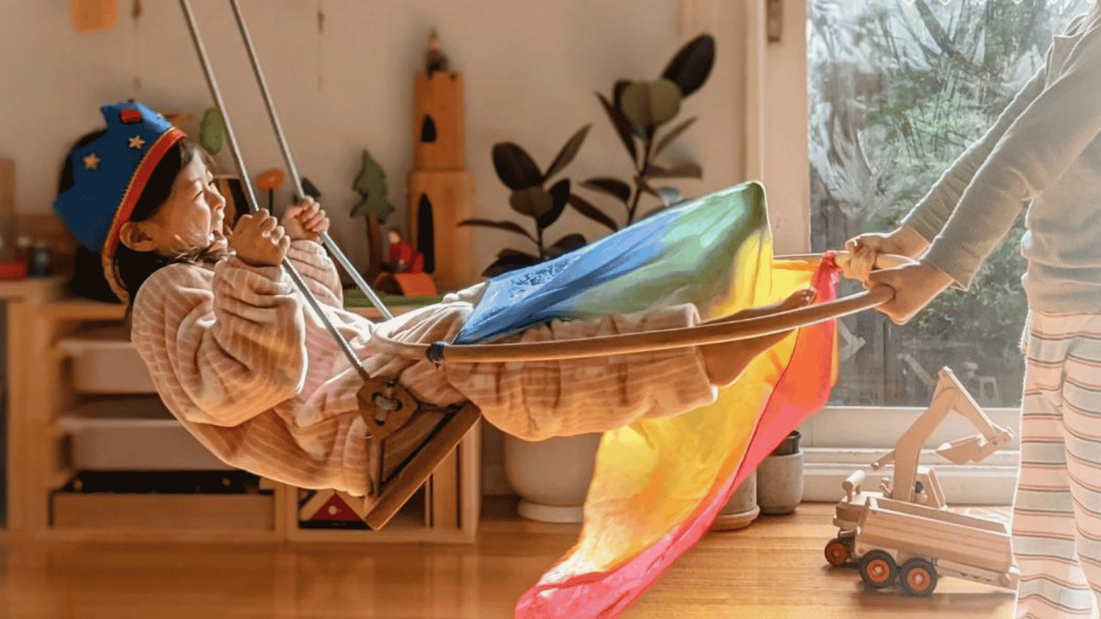 A girl playing on a Solvej Swing.