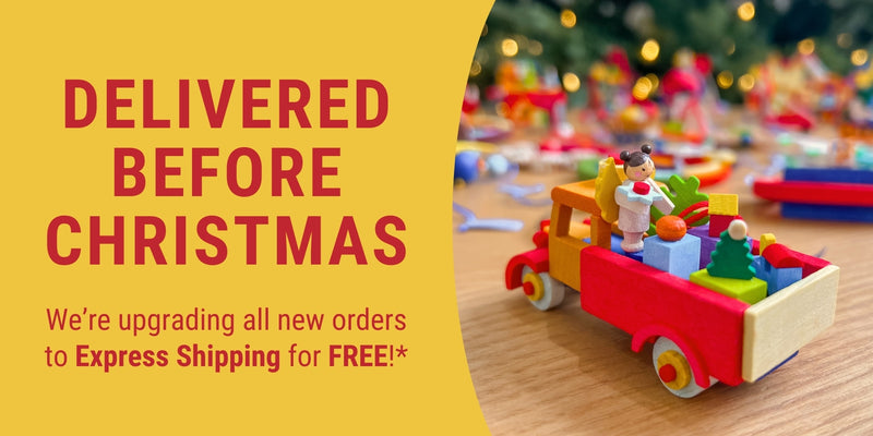 Wooden Graupner truck with children figurines on a yellow background with Christmas text.