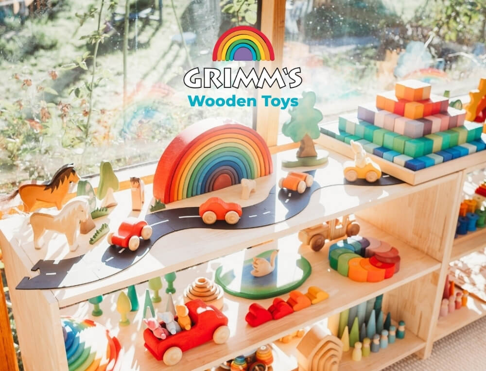 Grimm's Wooden Toys lifestyle image with logo, featuring a wooden toy display shelf filled with colourful Grimm's Wooden Toys, including a rainbow, cars and blocks – Oskar's Wooden Ark