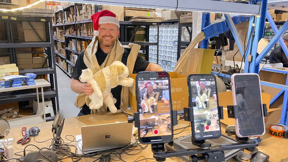 Simon at Oskar's Wooden Ark packing Christmas orders for a livestream event with customers