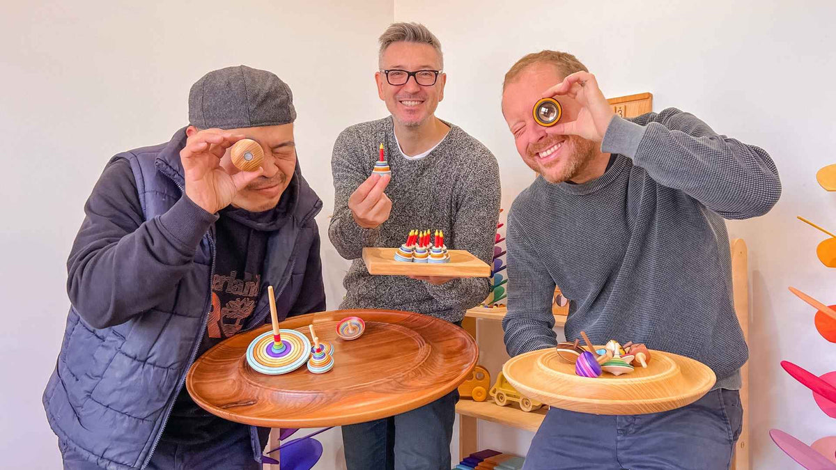 Oskar's Wooden Ark team holding Mader spinning tops and wooden spinning plates at a Mader Live event