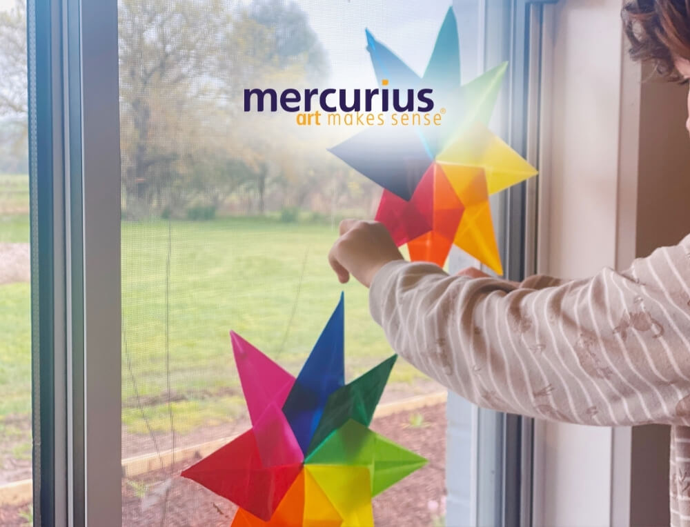 Mercurius lifestyle image with logo, featuring colourful, geometric Waldorf window stars folded with Mercurius kite paper – Oskar's Wooden Ark