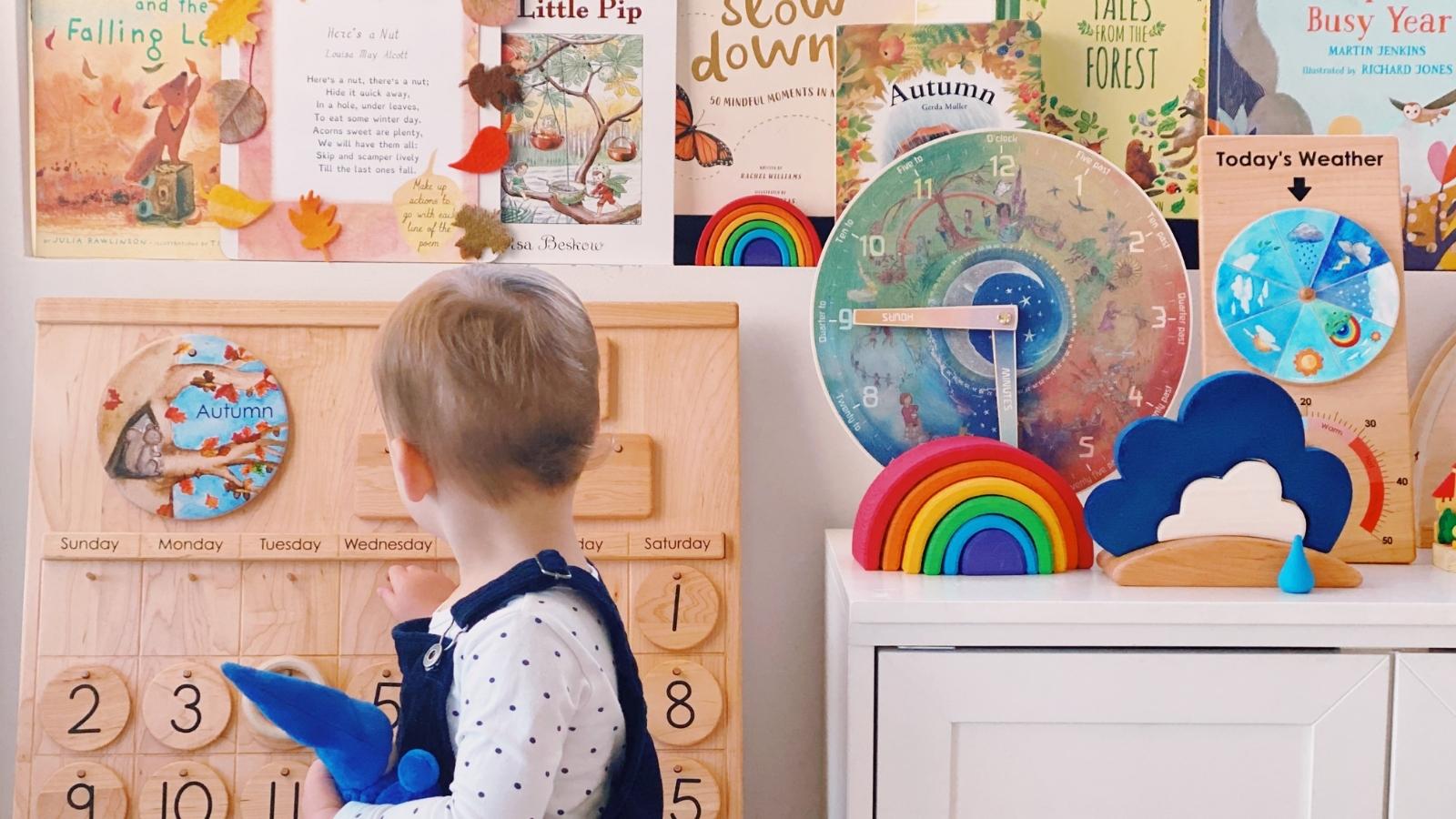 Child updating perpetual calendar as part of morning circle time - Oskar's Wooden Ark