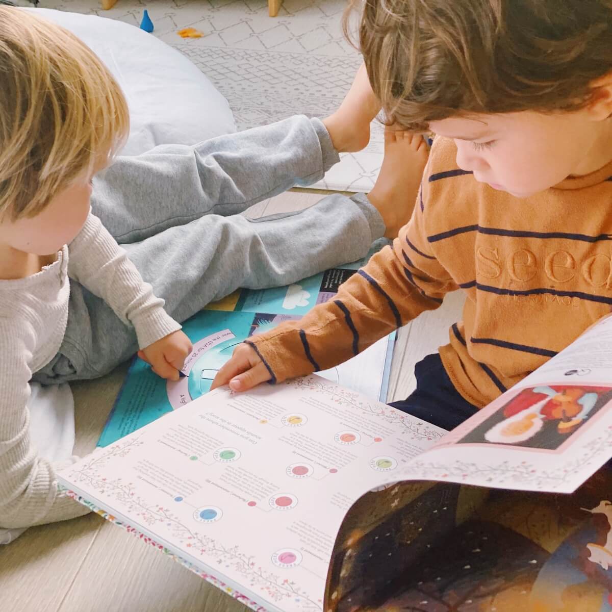 Children reading books together in morning circle time - Oskar's Wooden Ark