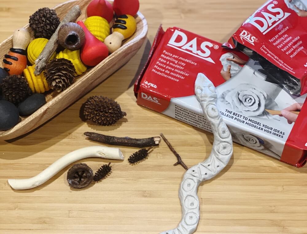 Handmade Rainbow Serpent moulded from DAS air-dry modelling clay, decorated with natural twig and gumnut patterns