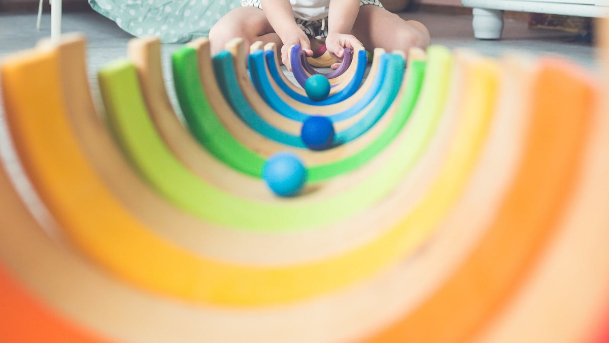 Balls running down a Grimm's marble track, created using the arches of a rainbow