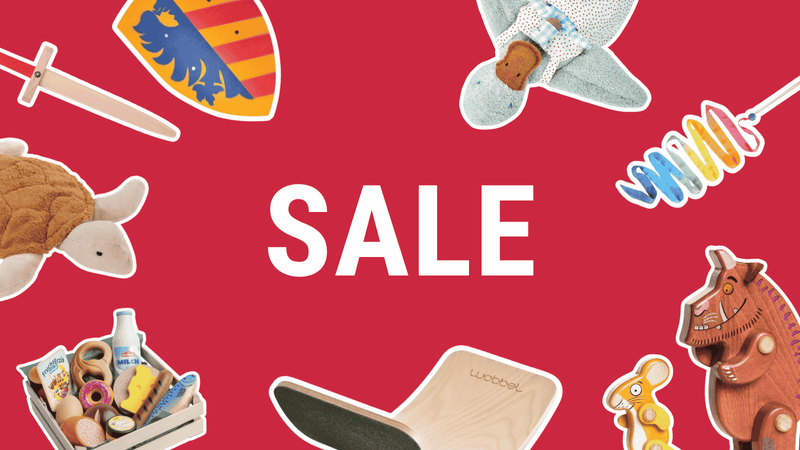 A promotional sale graphic with the word SALE in large white letters on a red background, surrounded by cutout illustrations of toys including a VAH sword and shield, stuffed animals, toy Gruffalo figures, Wobbel board, silk streamer and assorted Erzi play food from Oskar's Wooden Ark.