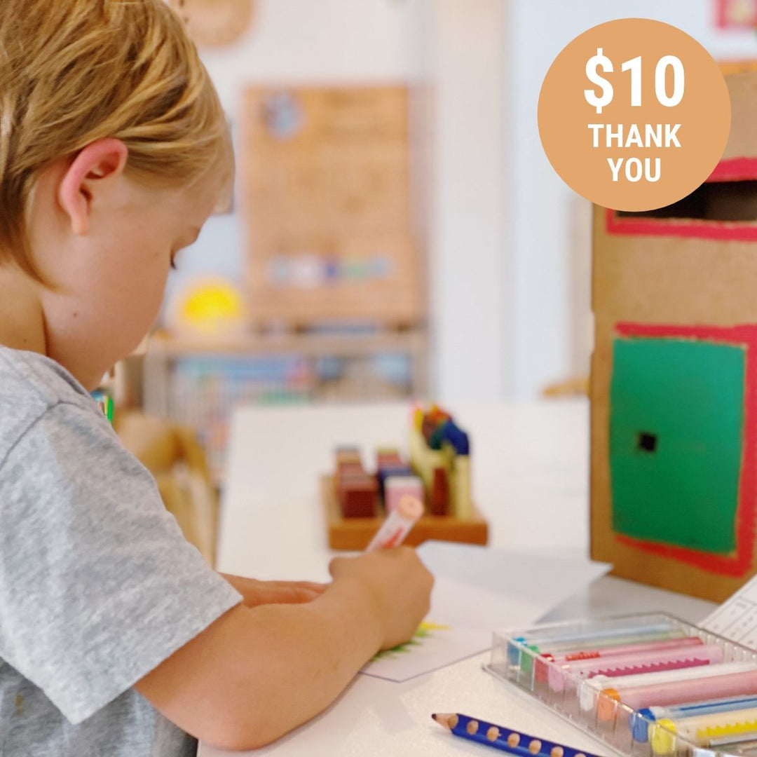 Child writing a letter, ready to post in a handcrafted postbox  with a "$10 thank you" badge