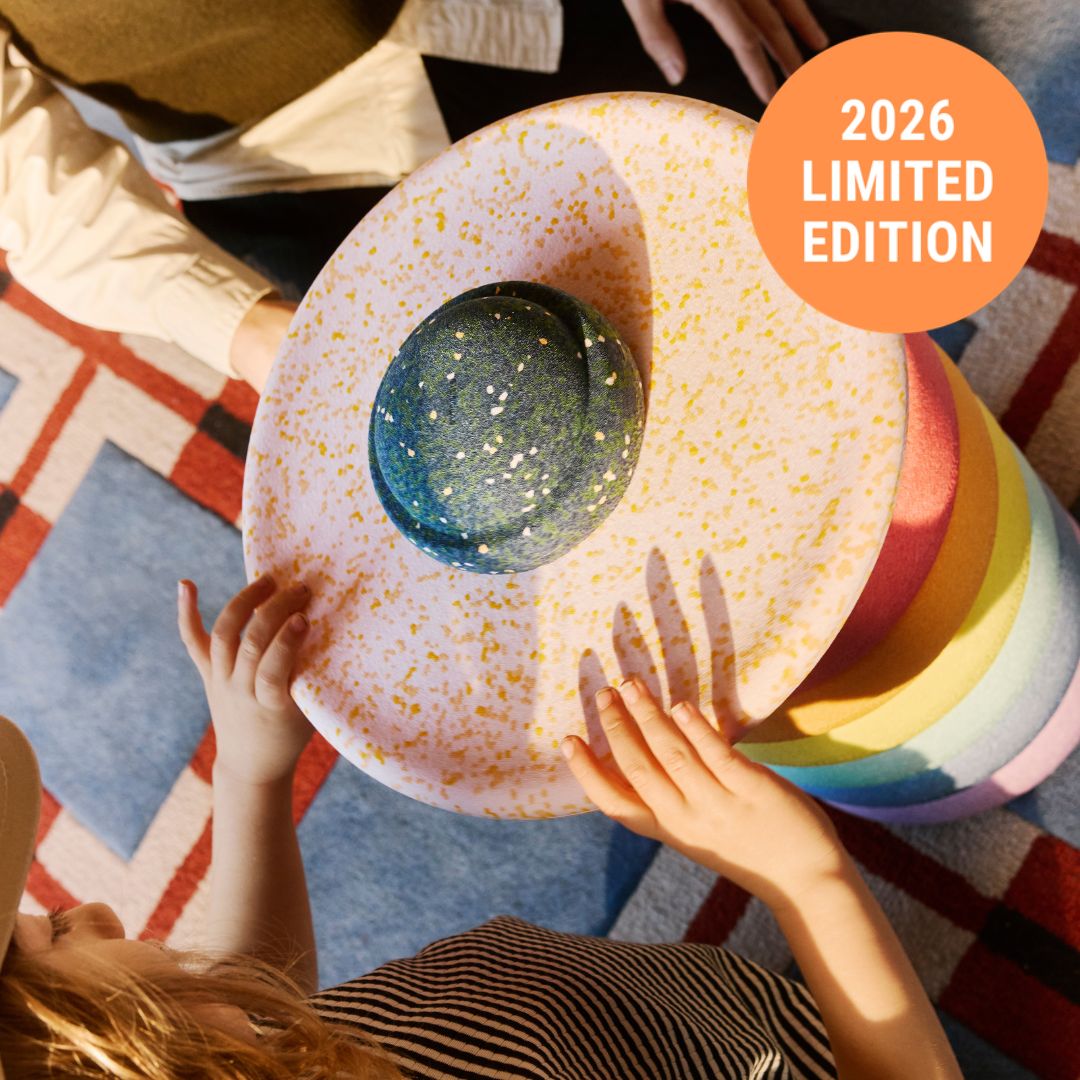 Colorful balancing stones with '2026 Limited Edition' label on a patterned rug.