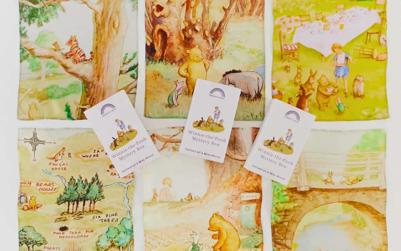Set of illustrated Winnie the Pooh mini playsilks on a white background