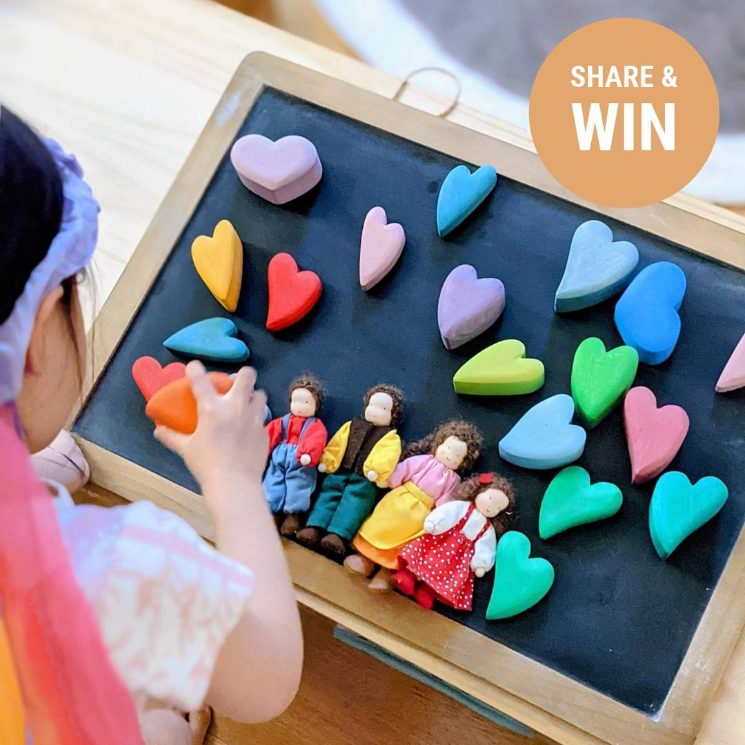 Child creating an image with Grimm's soft dolls and wooden hearts  with a "share and win" badge
