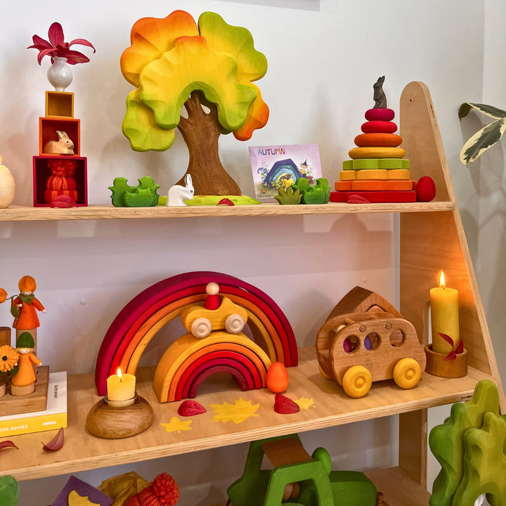 Wooden toys displayed on a shelf, arranged for an autumn-themed playroom decor in Australia