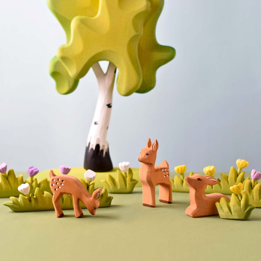 BumbuToys Handcrafted Wooden Animal Grazing Deer Fawn from Australia in a small-world play setting