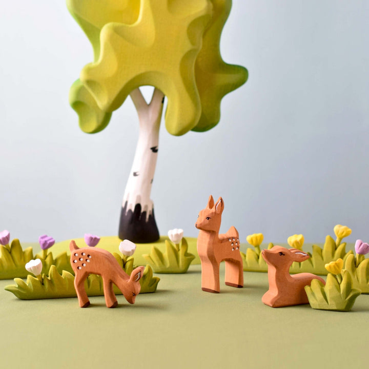 BumbuToys Handcrafted Wooden Animal Grazing Deer Fawn from Australia in a small-world play setting