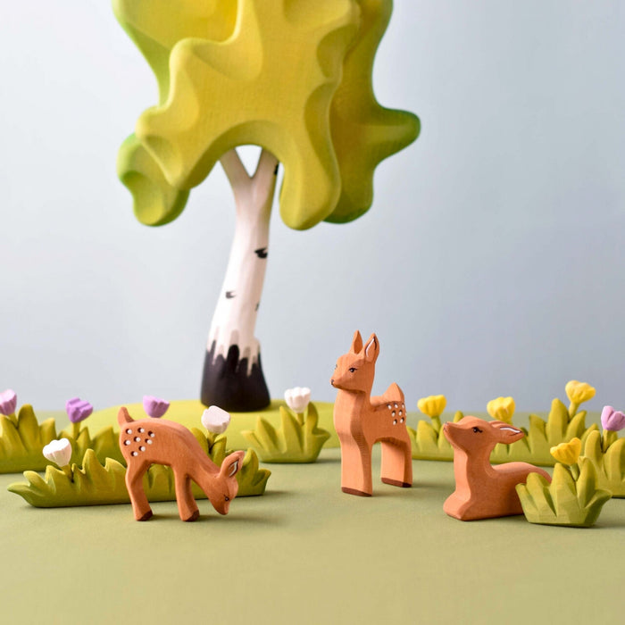 BumbuToys Handcrafted Wooden Animal Grazing Deer Fawn from Australia in a small-world play setting
