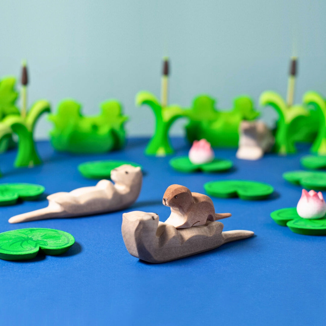 BumbuToys Handcrafted Wooden Animal Sleeping Otter from Australia in a small-world play setting