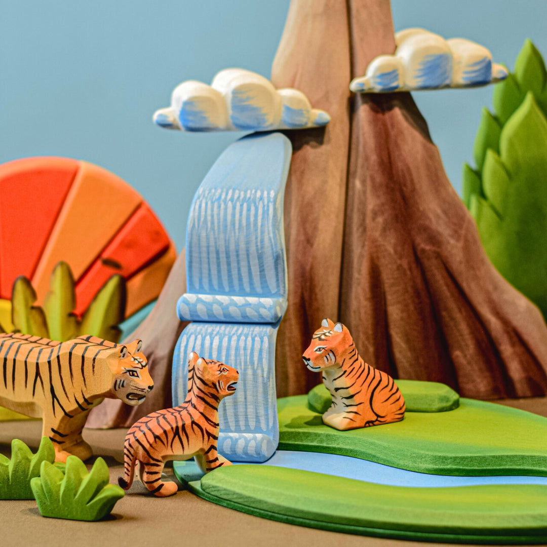 BumbuToys Handcrafted Wooden Animal Tiger Cub Sitting in a small-world play setting
