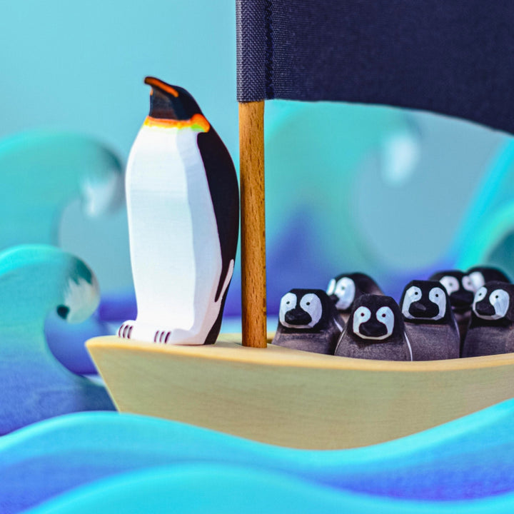 BumbuToys Handcrafted Wooden Bird Emperor Penguins from Australia in a small-world play setting
