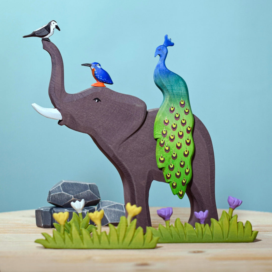 BumbuToys Handcrafted Wooden Bird Peacock from Australia in a small-world play setting