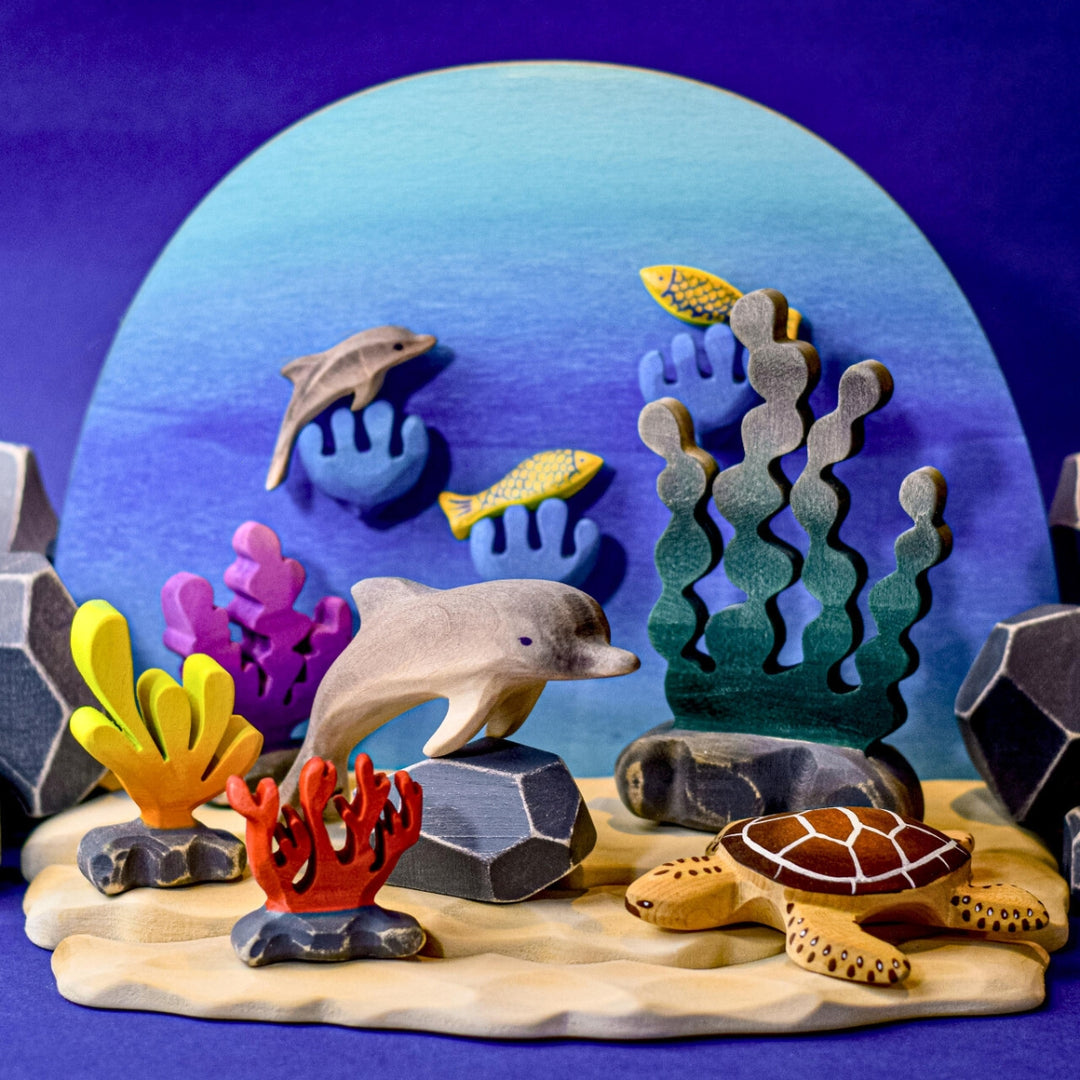 BumbuToys Handcrafted Wooden Dolphin from Australia in an ocean small-world play setting