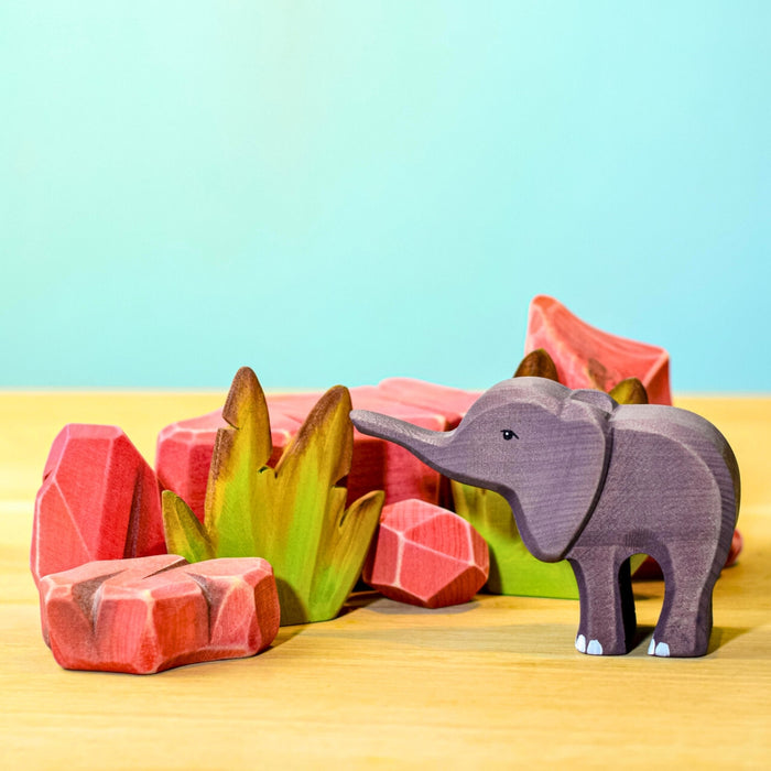 BumbuToys Handcrafted Wooden Landscape Savanna Rocks Set of 5 from Australia in a small-world play setting