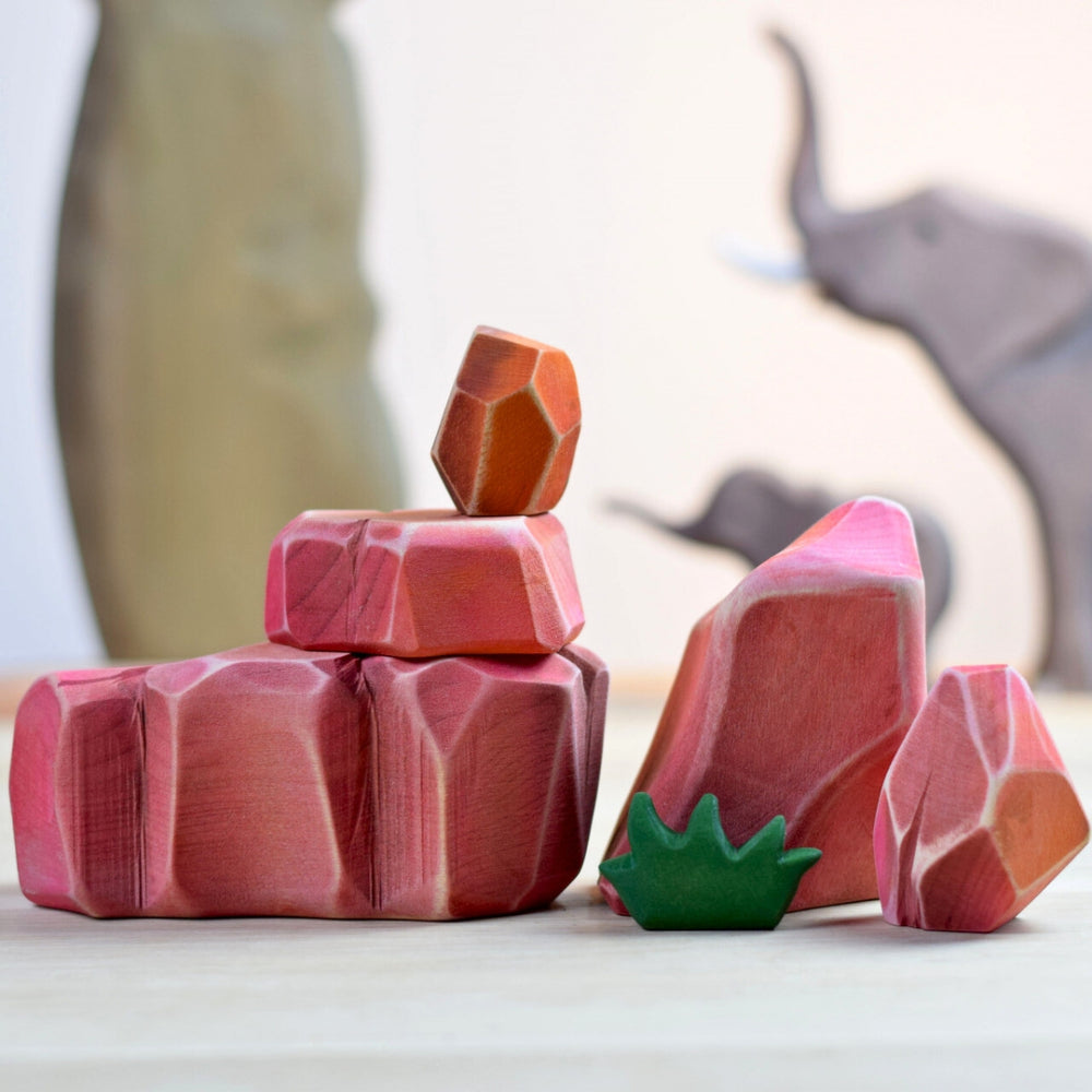 BumbuToys Handcrafted Wooden Landscape Savanna Rocks Set of 5 from Australia in a small-world play setting