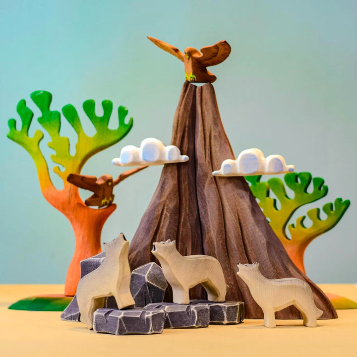 BumbuToys Handcrafted Wooden Figure Landscape Volcano, Lava, and Clouds Set of 5 from Australia in a small-world play setting