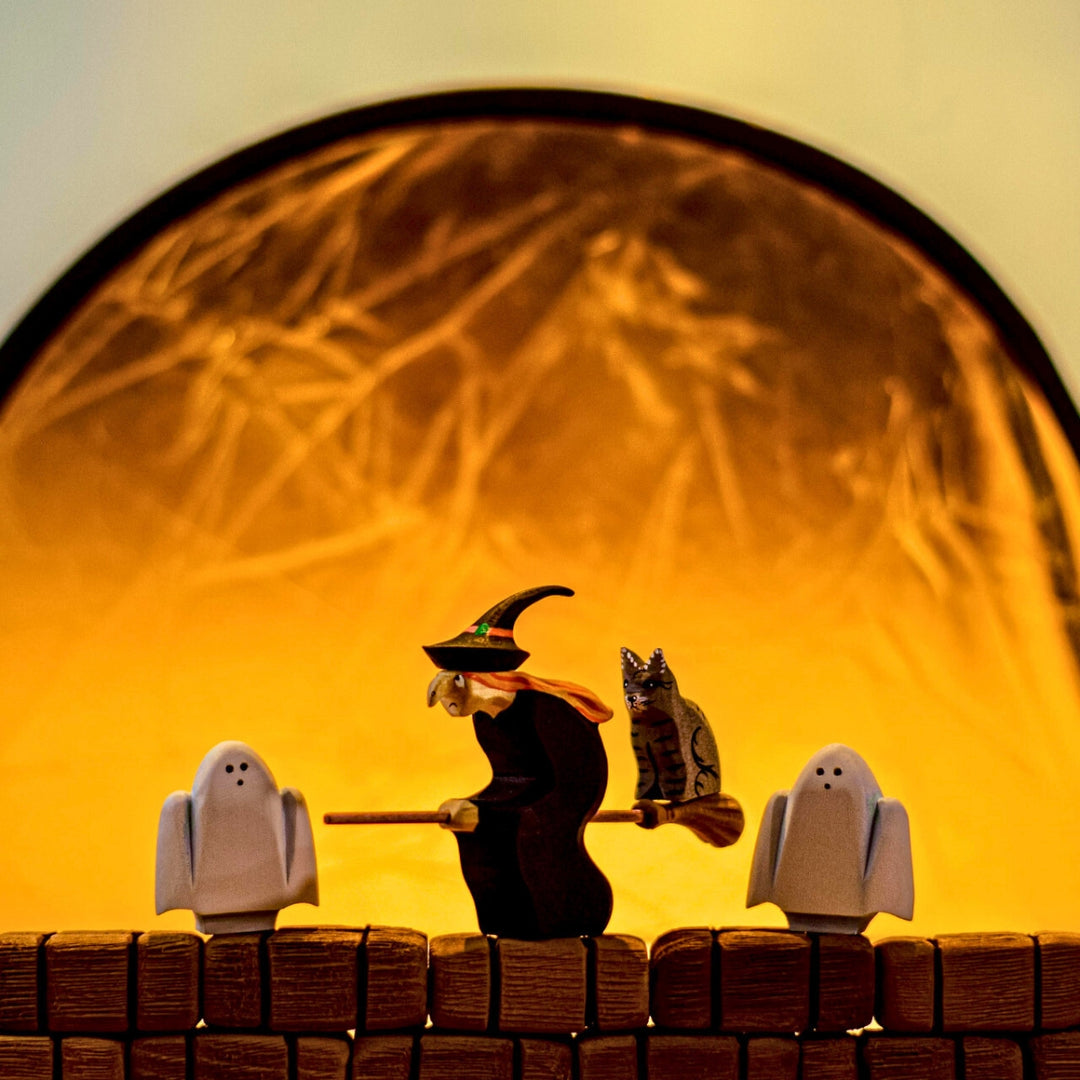 BumbuToys Handcrafted Wooden Witch Figure from Australia in a small-world play setting