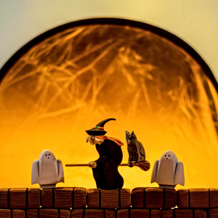 BumbuToys Handcrafted Wooden Witch Figure from Australia in a small-world play setting